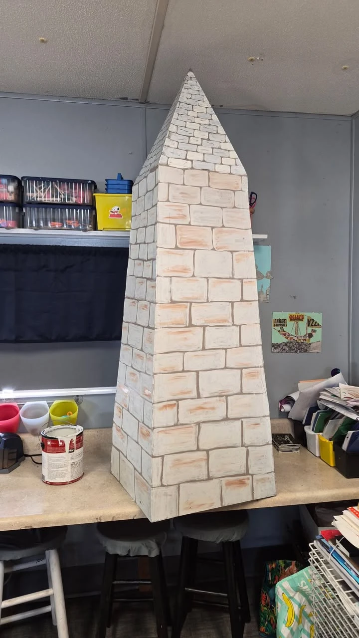 Hand-painted brick obelisk sculpture by a Genesis Prep student