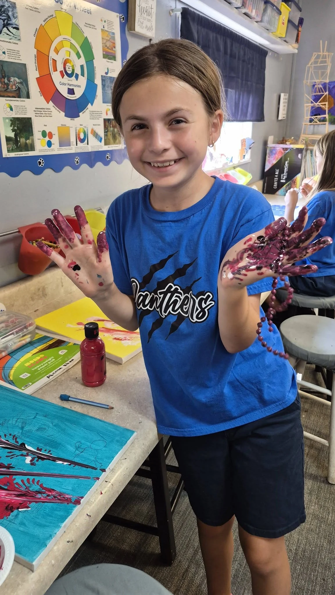 Genesis Prep student working with paint in art class